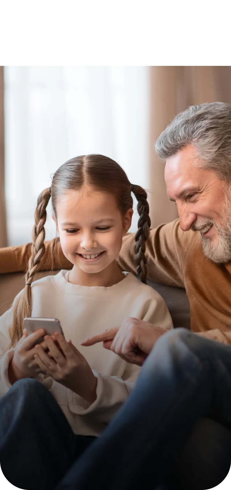 Grandfather and granddaughter watching birds on a phone